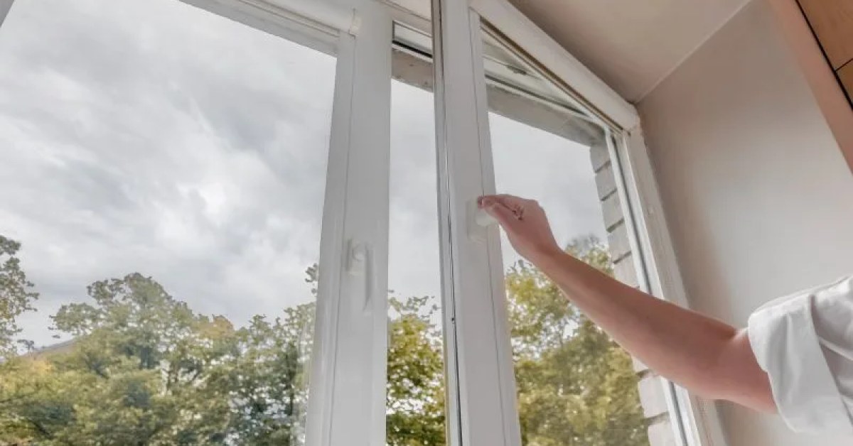 Vinyl window with visible sash and locking hardware